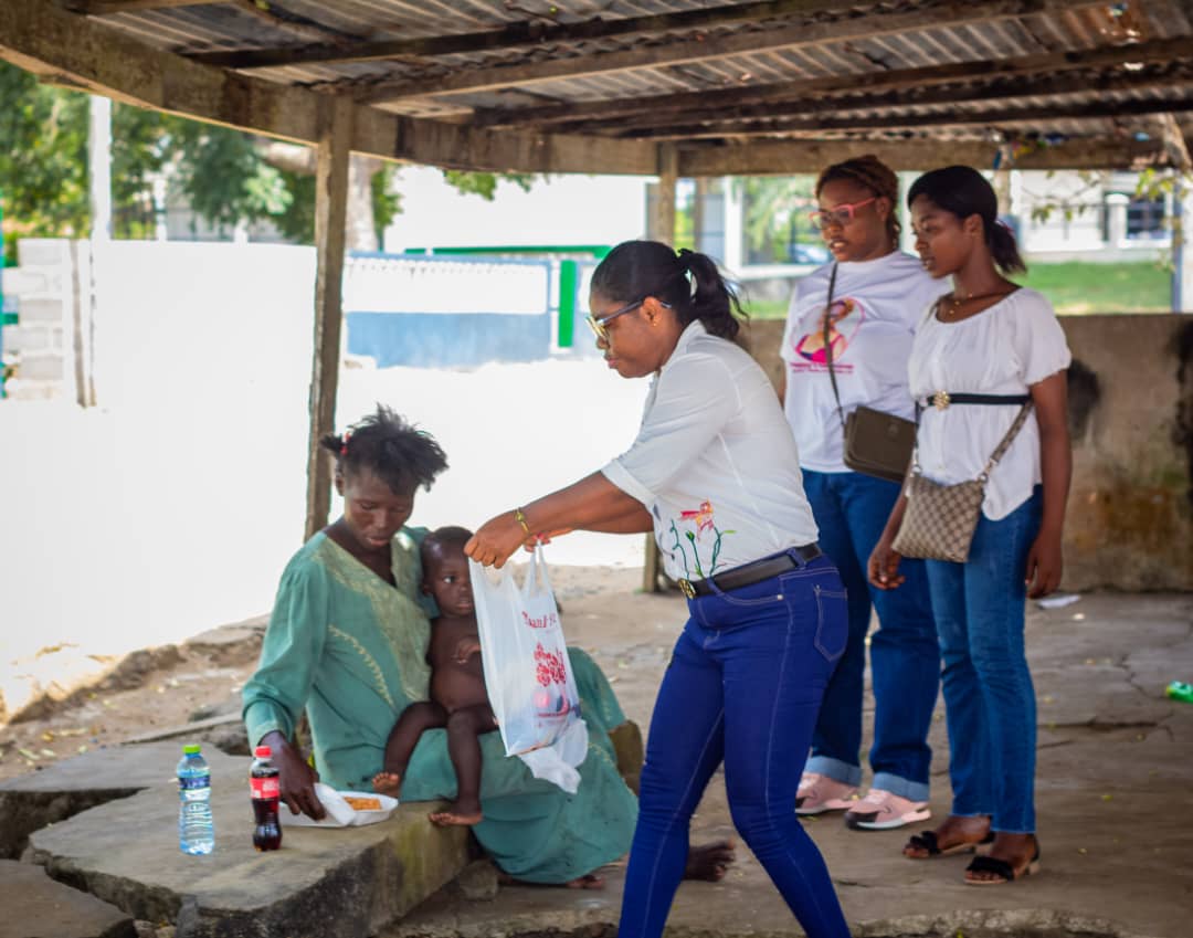 Foundation volunteers providing support to a mother and child during a community outreach visit